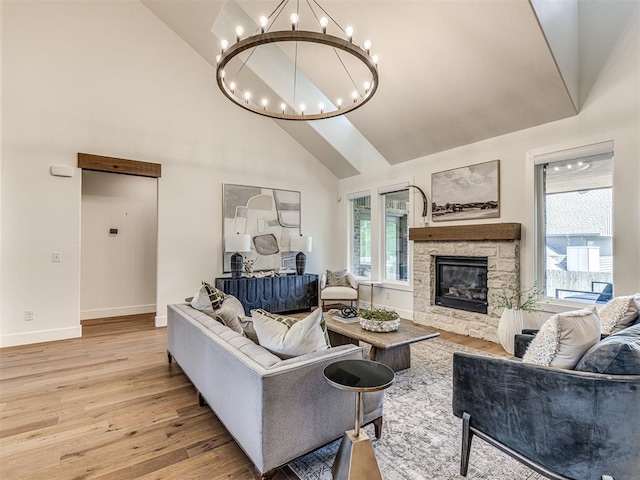 7308 Sunset Sail Ave, Edmond, OK 73034 - living area featuring high vaulted ceiling, a chandelier, wood finished floors, and a stone fireplace