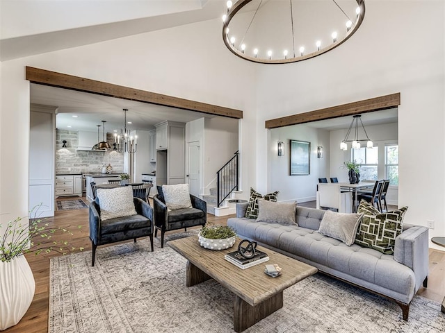 7308 Sunset Sail Ave, Edmond, OK 73034 - living room with a chandelier, wood finished floors, a high ceiling, and stairway