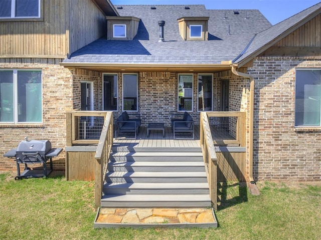 7308 Sunset Sail Ave, Edmond, OK 73034 - property entrance with brick siding, a yard, and a wooden deck