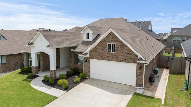 15921 Bison Dr, Moore, OK 73170 - view of front facade with brick siding, concrete driveway, a garage, and roof with shingles