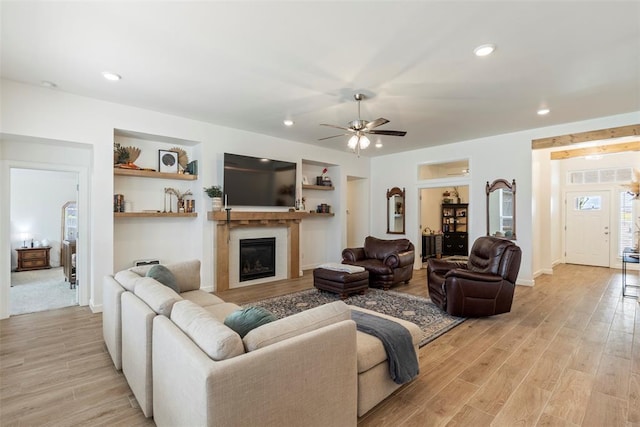 15921 Bison Dr, Moore, OK 73170 - living room with a ceiling fan, light wood-style floors, a glass covered fireplace, and recessed lighting