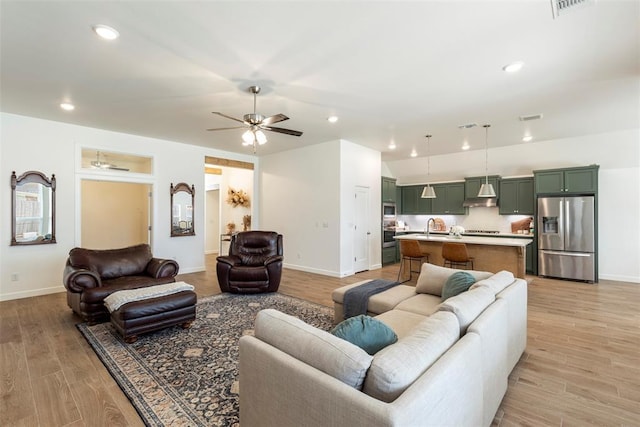 15921 Bison Dr, Moore, OK 73170 - living area with ceiling fan, light wood-style floors, and recessed lighting