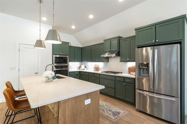 15921 Bison Dr, Moore, OK 73170 - kitchen featuring stainless steel appliances, green cabinetry, under cabinet range hood, light stone countertops, and backsplash