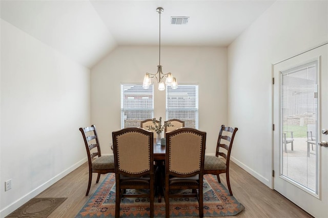 15921 Bison Dr, Moore, OK 73170 - dining room featuring a chandelier, healthy amount of natural light, light wood-type flooring, and vaulted ceiling