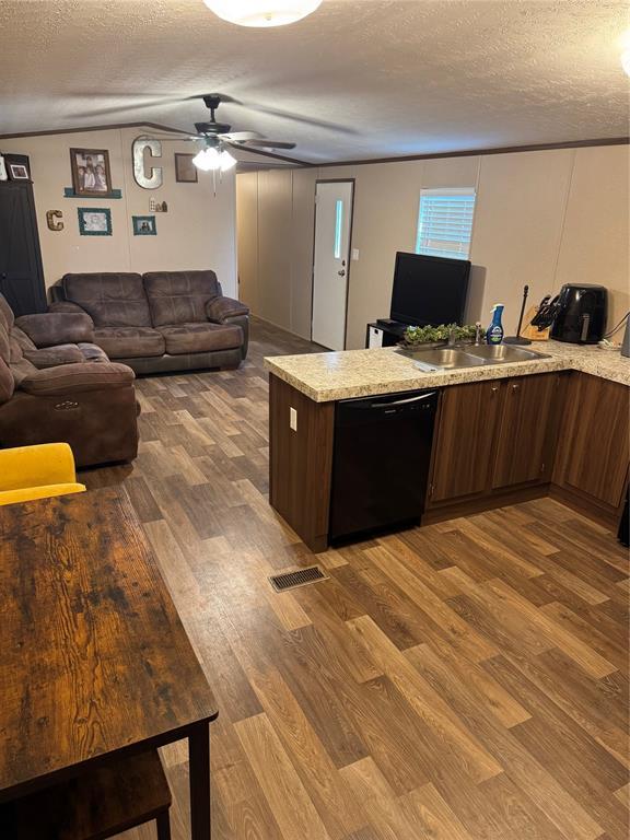 330633 E 875th Rd, Wellston, OK 74881 - kitchen featuring dishwasher, wood finished floors, a textured ceiling, ceiling fan, and open floor plan