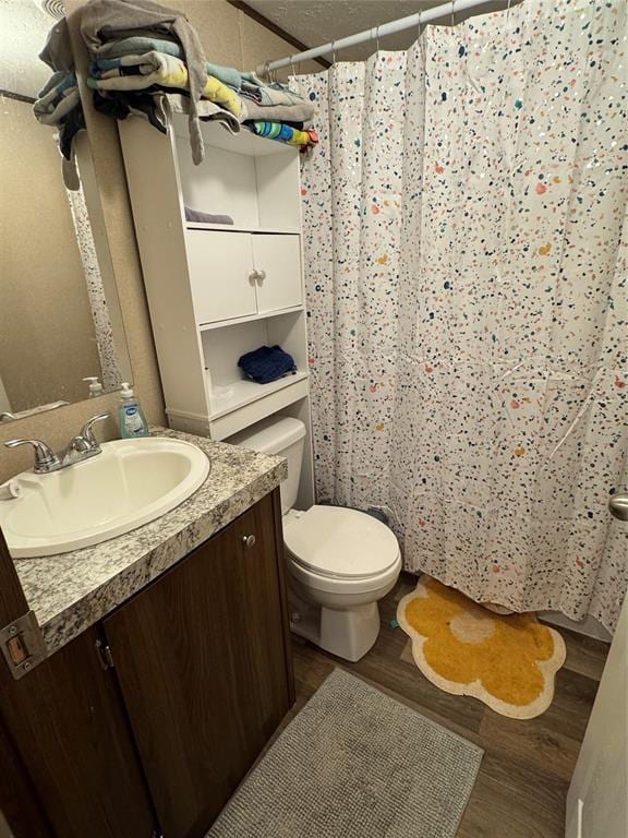 330633 E 875th Rd, Wellston, OK 74881 - full bathroom with vanity, wood finished floors, and a shower with shower curtain