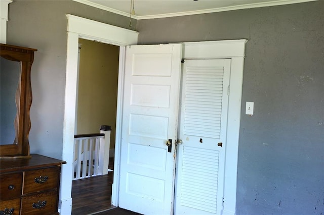 120 S Chickasaw Ave, Bartlesville, OK 74003 - unfurnished bedroom featuring crown molding, a closet, and dark wood-style floors