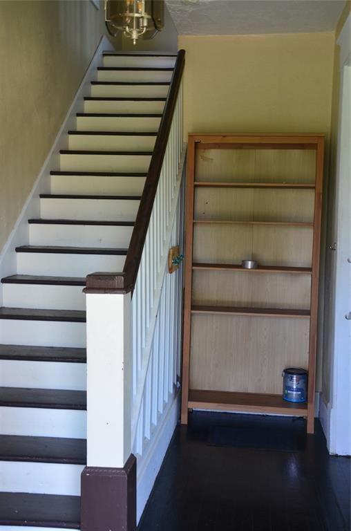 120 S Chickasaw Ave, Bartlesville, OK 74003 - stairs with wood finished floors and a chandelier