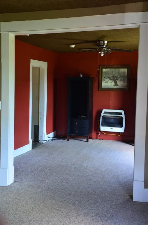 120 S Chickasaw Ave, Bartlesville, OK 74003 - living area with heating unit, carpet flooring, and ceiling fan