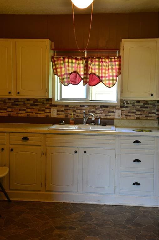 120 S Chickasaw Ave, Bartlesville, OK 74003 - kitchen with backsplash, light countertops, plenty of natural light, and white cabinetry