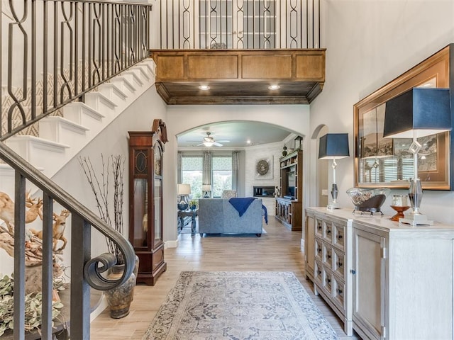 13308 NW 6th St, Yukon, OK 73099 - foyer featuring arched walkways, a ceiling fan, a towering ceiling, stairway, and ornamental molding