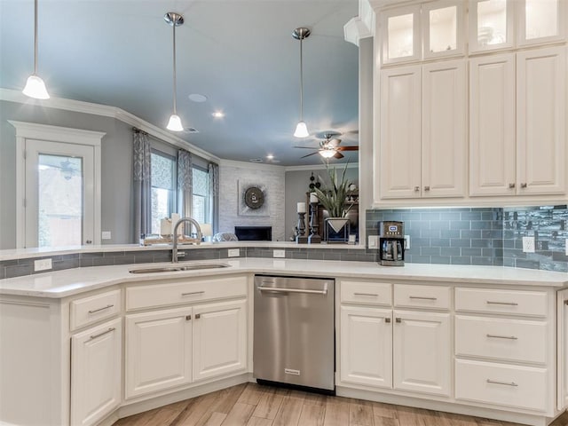 13308 NW 6th St, Yukon, OK 73099 - kitchen featuring stainless steel dishwasher, ornamental molding, decorative backsplash, a large fireplace, and ceiling fan