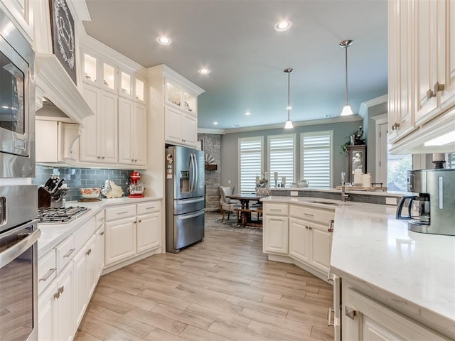 13308 NW 6th St, Yukon, OK 73099 - kitchen with stainless steel appliances, healthy amount of natural light, crown molding, pendant lighting, and tasteful backsplash