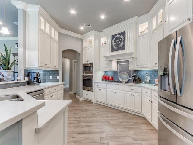 13308 NW 6th St, Yukon, OK 73099 - kitchen featuring stainless steel appliances, crown molding, backsplash, white cabinets, and arched walkways