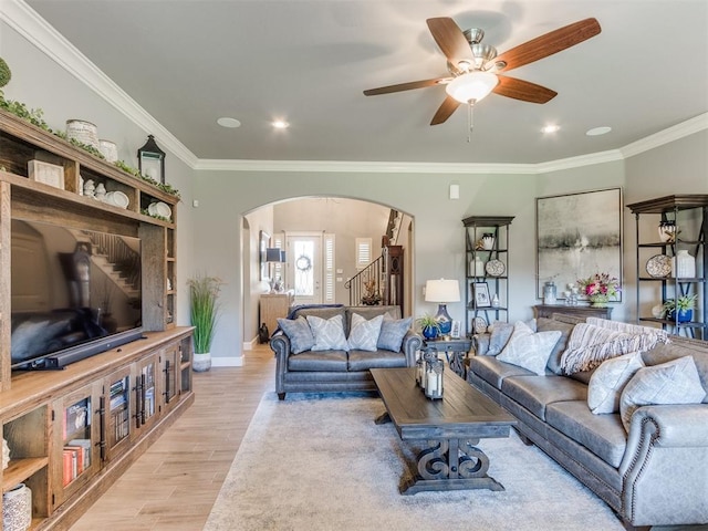 13308 NW 6th St, Yukon, OK 73099 - living area with arched walkways, crown molding, light wood finished floors, stairway, and a ceiling fan