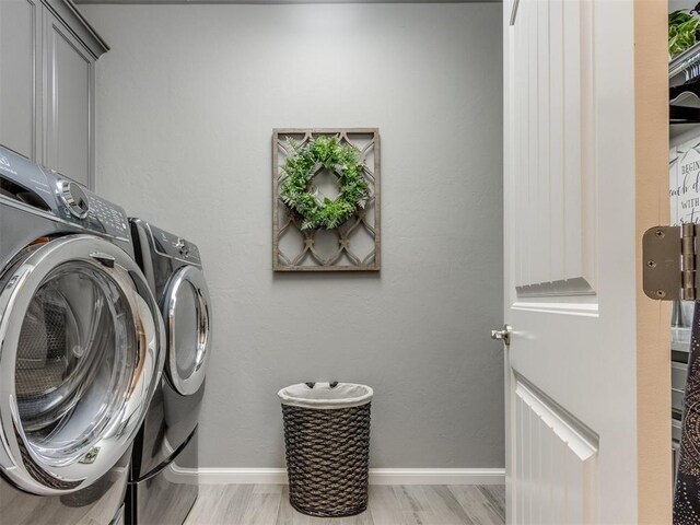 13308 NW 6th St, Yukon, OK 73099 - laundry area featuring washing machine and clothes dryer, cabinet space, and light wood-style floors