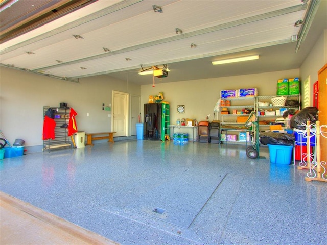 13308 NW 6th St, Yukon, OK 73099 - garage featuring a garage door opener and black fridge