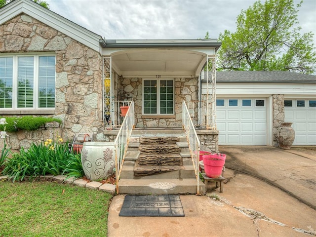 720 NW 49th St, Oklahoma City, OK 73118 - property entrance with stone siding, a porch, driveway, and an attached garage