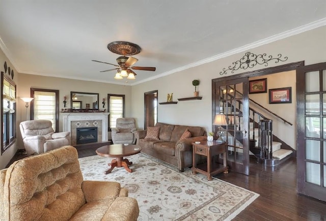 13902 Valley View Rd, Shawnee, OK 74804 - living area with a fireplace, dark wood-type flooring, ornamental molding, stairs, and a ceiling fan
