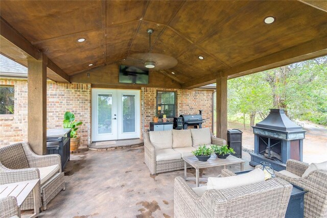 19277 E 1220th Rd, Sayre, OK 73662 - view of patio / terrace featuring french doors, an outdoor living space with a fireplace, and area for grilling
