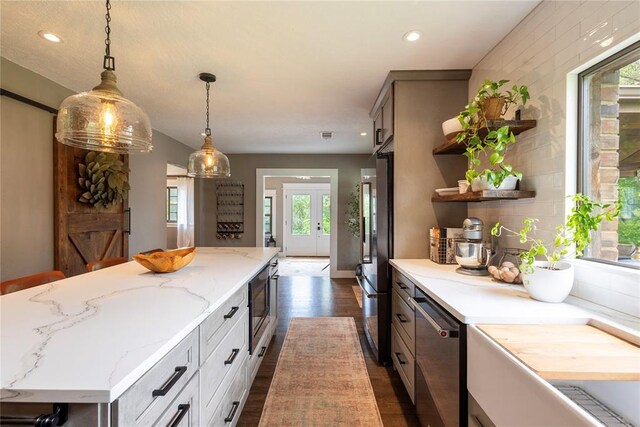 19277 E 1220th Rd, Sayre, OK 73662 - kitchen featuring plenty of natural light, a center island, stainless steel appliances, dark wood finished floors, and recessed lighting