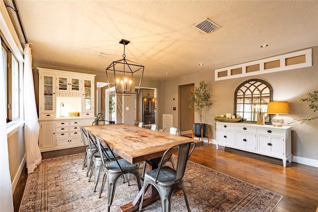 19277 E 1220th Rd, Sayre, OK 73662 - dining area with dark wood-type flooring and a chandelier
