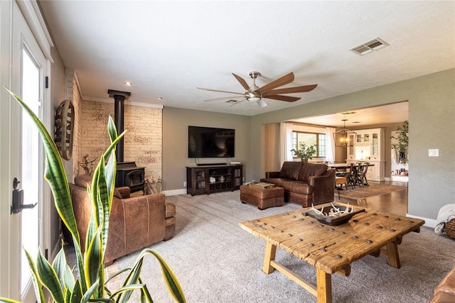 19277 E 1220th Rd, Sayre, OK 73662 - living room with a ceiling fan, carpet floors, and a wood stove