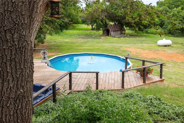 19277 E 1220th Rd, Sayre, OK 73662 - outdoor pool featuring a wooden deck, a yard, and an outbuilding