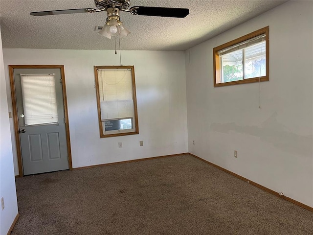 1333 Reid St, Seminole, OK 74868 - carpeted spare room with a textured ceiling and ceiling fan