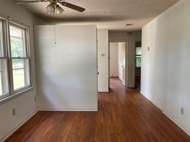 1333 Reid St, Seminole, OK 74868 - unfurnished room featuring wood finished floors, healthy amount of natural light, and a textured ceiling