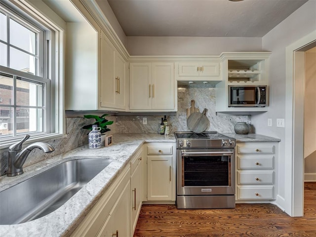 6432 Brandywine Ln, Oklahoma City, OK 73116 - kitchen featuring appliances with stainless steel finishes, dark wood finished floors, tasteful backsplash, light stone countertops, and white cabinets