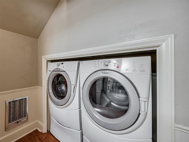 6432 Brandywine Ln, Oklahoma City, OK 73116 - laundry room featuring heating unit, dark wood-type flooring, and washing machine and clothes dryer