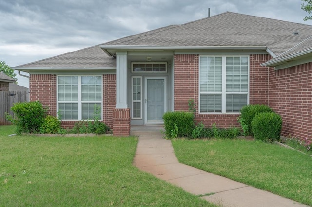 2412 NW 164th Ter, Edmond, OK 73013 - doorway to property featuring brick siding and a shingled roof
