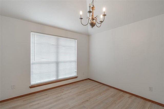 2412 NW 164th Ter, Edmond, OK 73013 - spare room featuring a chandelier and light wood-style flooring