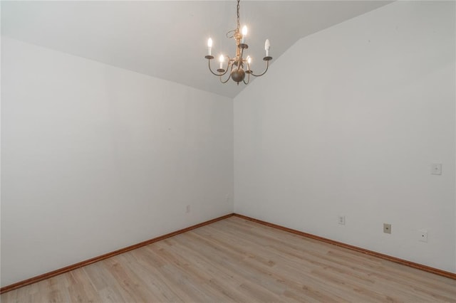 2412 NW 164th Ter, Edmond, OK 73013 - spare room featuring lofted ceiling, a chandelier, and light wood-type flooring