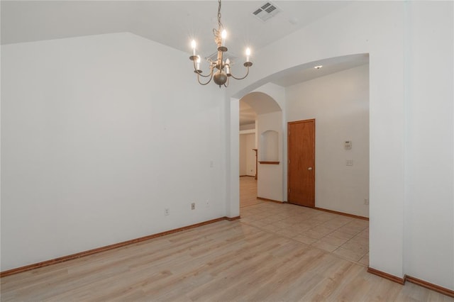 2412 NW 164th Ter, Edmond, OK 73013 - spare room featuring arched walkways, a chandelier, light wood-type flooring, and lofted ceiling