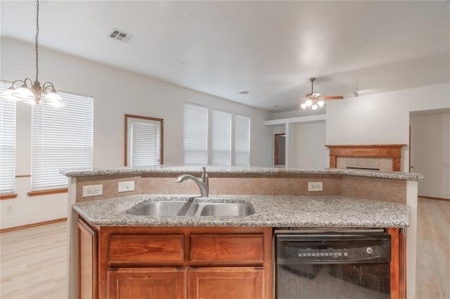 2412 NW 164th Ter, Edmond, OK 73013 - kitchen with dishwasher, light wood-style flooring, open floor plan, a ceiling fan, and brown cabinets