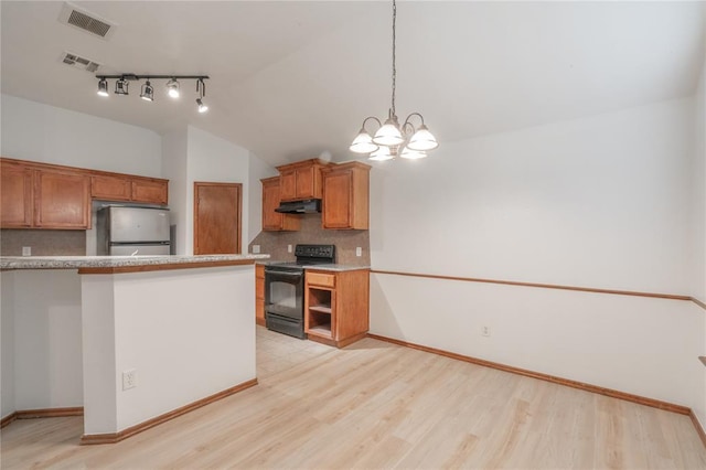 2412 NW 164th Ter, Edmond, OK 73013 - kitchen with black electric range oven, freestanding refrigerator, decorative backsplash, light wood finished floors, and under cabinet range hood