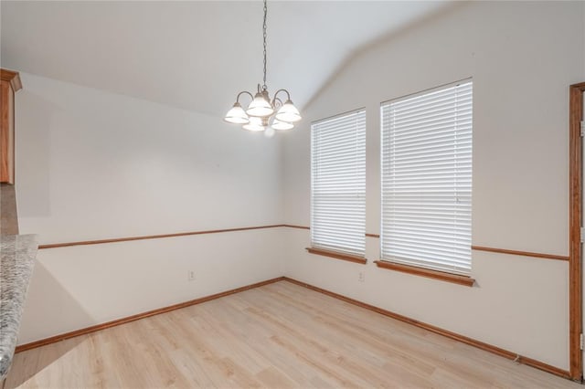 2412 NW 164th Ter, Edmond, OK 73013 - spare room featuring light wood-style flooring, vaulted ceiling, and a chandelier
