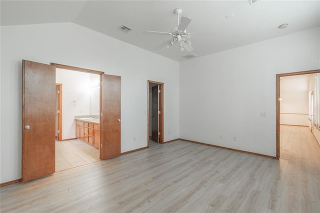 2412 NW 164th Ter, Edmond, OK 73013 - unfurnished bedroom featuring light wood-type flooring, lofted ceiling, connected bathroom, and a ceiling fan