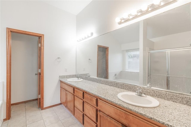 2412 NW 164th Ter, Edmond, OK 73013 - bathroom featuring double vanity, a garden tub, a shower stall, tile patterned floors, and lofted ceiling