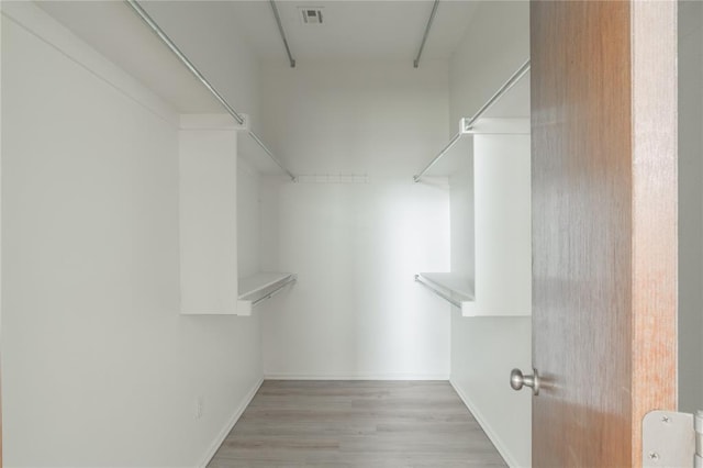 2412 NW 164th Ter, Edmond, OK 73013 - walk in closet featuring wood finished floors