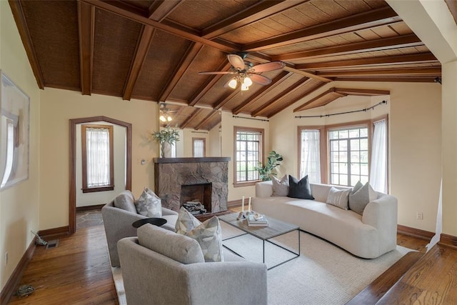 217 NW 30th St, Oklahoma City, OK 73118 - living room featuring wood ceiling, wood finished floors, a stone fireplace, and a ceiling fan