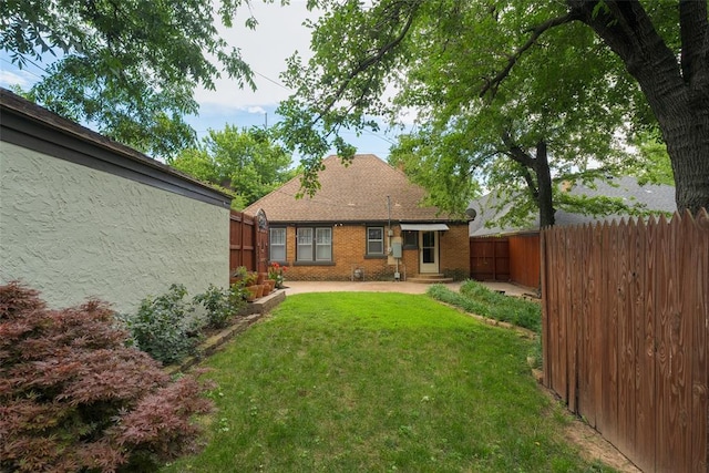 217 NW 30th St, Oklahoma City, OK 73118 - back of property with a patio, a fenced backyard, and brick siding