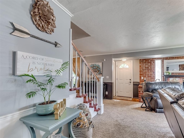 4603 N Wheeler Ave, Bethany, OK 73008 - foyer featuring a textured ceiling, carpet floors, stairs, ornamental molding, and wainscoting