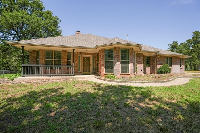 14601 Billy Dr, Edmond, OK 73034 - view of front of house with brick siding, a porch, and a chimney