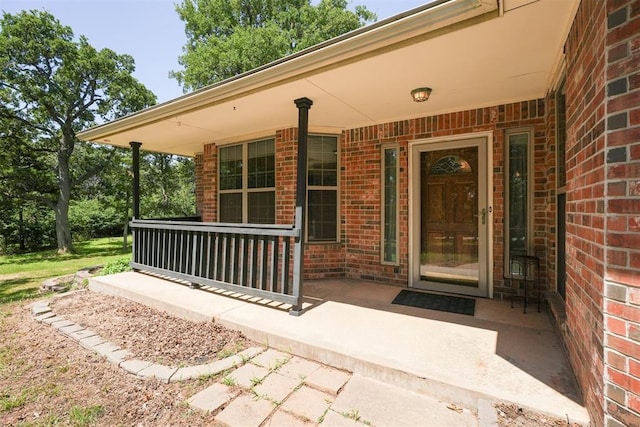 14601 Billy Dr, Edmond, OK 73034 - entrance to property featuring covered porch and brick siding