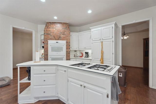 14601 Billy Dr, Edmond, OK 73034 - kitchen with white appliances, a chandelier, white cabinets, dark wood finished floors, and recessed lighting