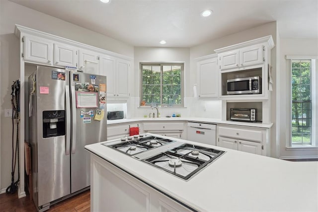 14601 Billy Dr, Edmond, OK 73034 - kitchen featuring appliances with stainless steel finishes, white cabinets, light countertops, and recessed lighting