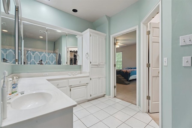 14601 Billy Dr, Edmond, OK 73034 - ensuite bathroom featuring double vanity, tile patterned flooring, ceiling fan, and a shower